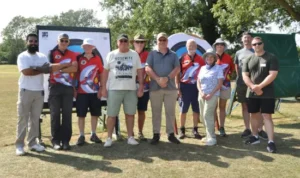A group of people standing in front of archery targets