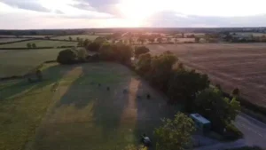Aerial shot taken by drone of an archery field and surrounding countryside